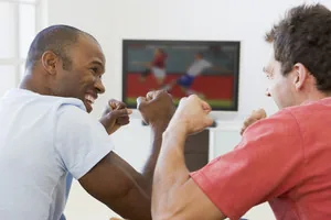 Football fans celebrating a World Cup 2026 goal while watching at home