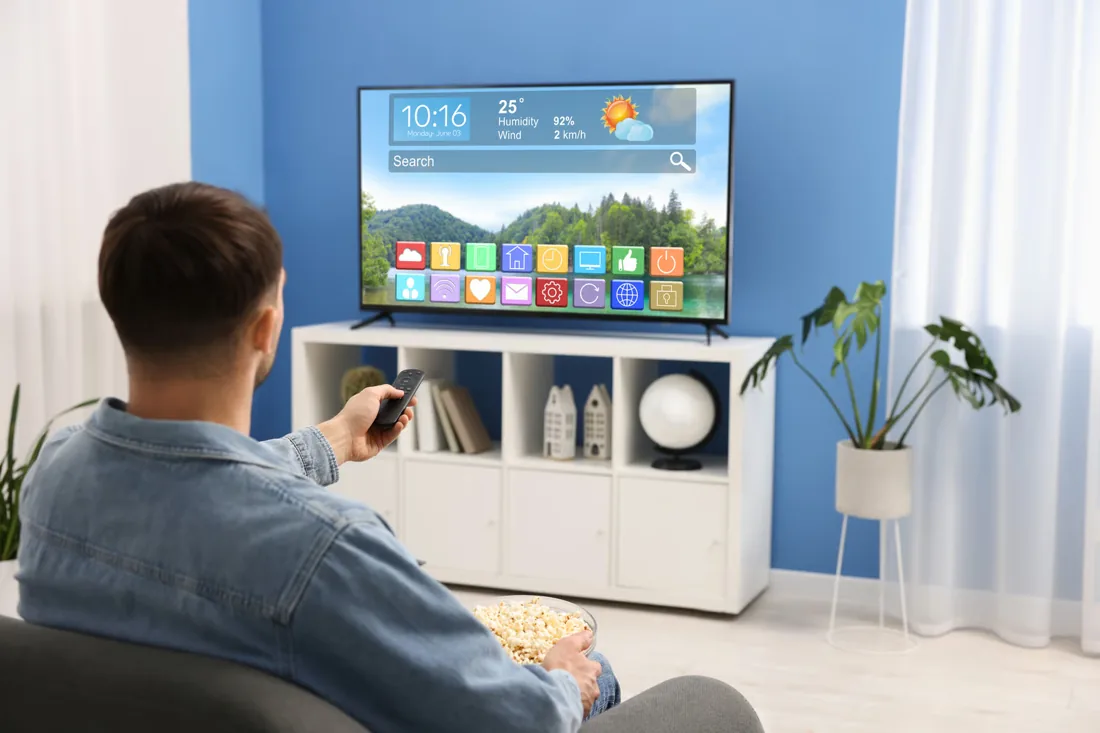 Man learning how to setup IPTV on a Smart TV at home