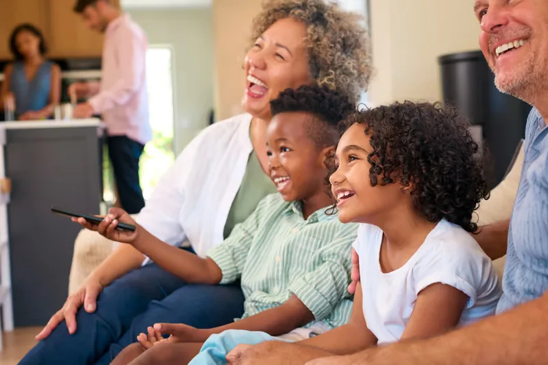 Family watching IPTV in 4K together on a Smart TV