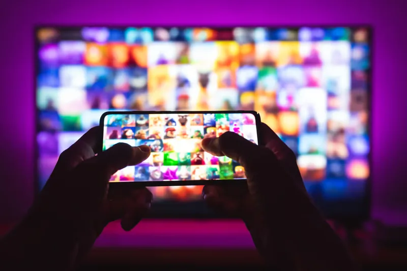 IPTV setup on a phone streaming content next to a TV