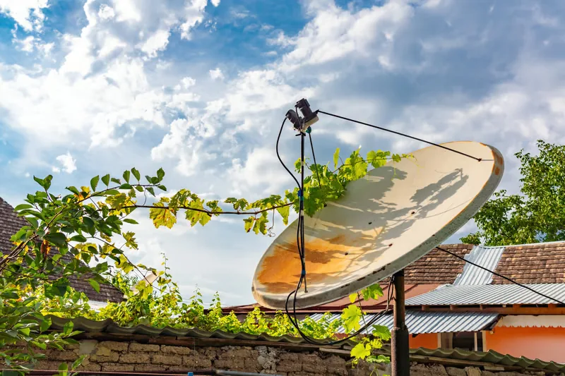 Old rusty satellite dish representing traditional cable TV setup