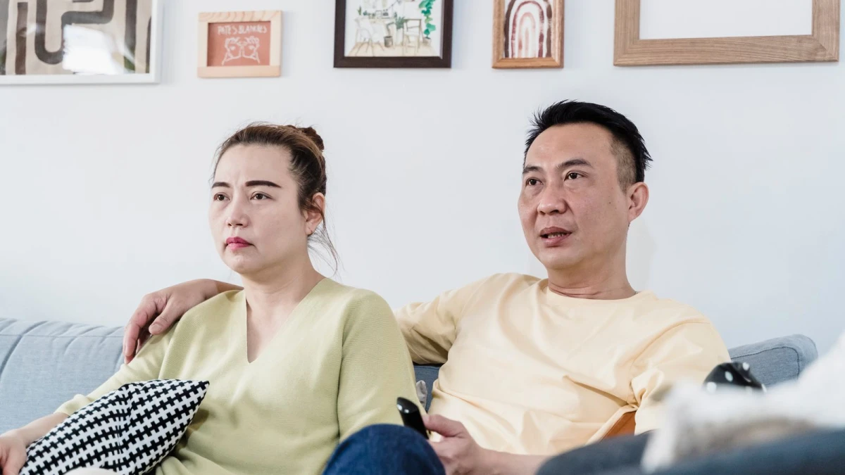 Couple watching TV at home with a remote during an IPTV trial